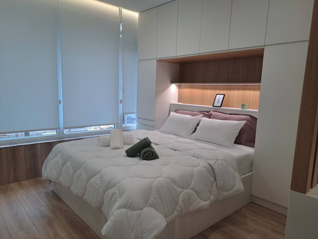 Comfy Studio bedroom with warm LED lighting and cozy bedding